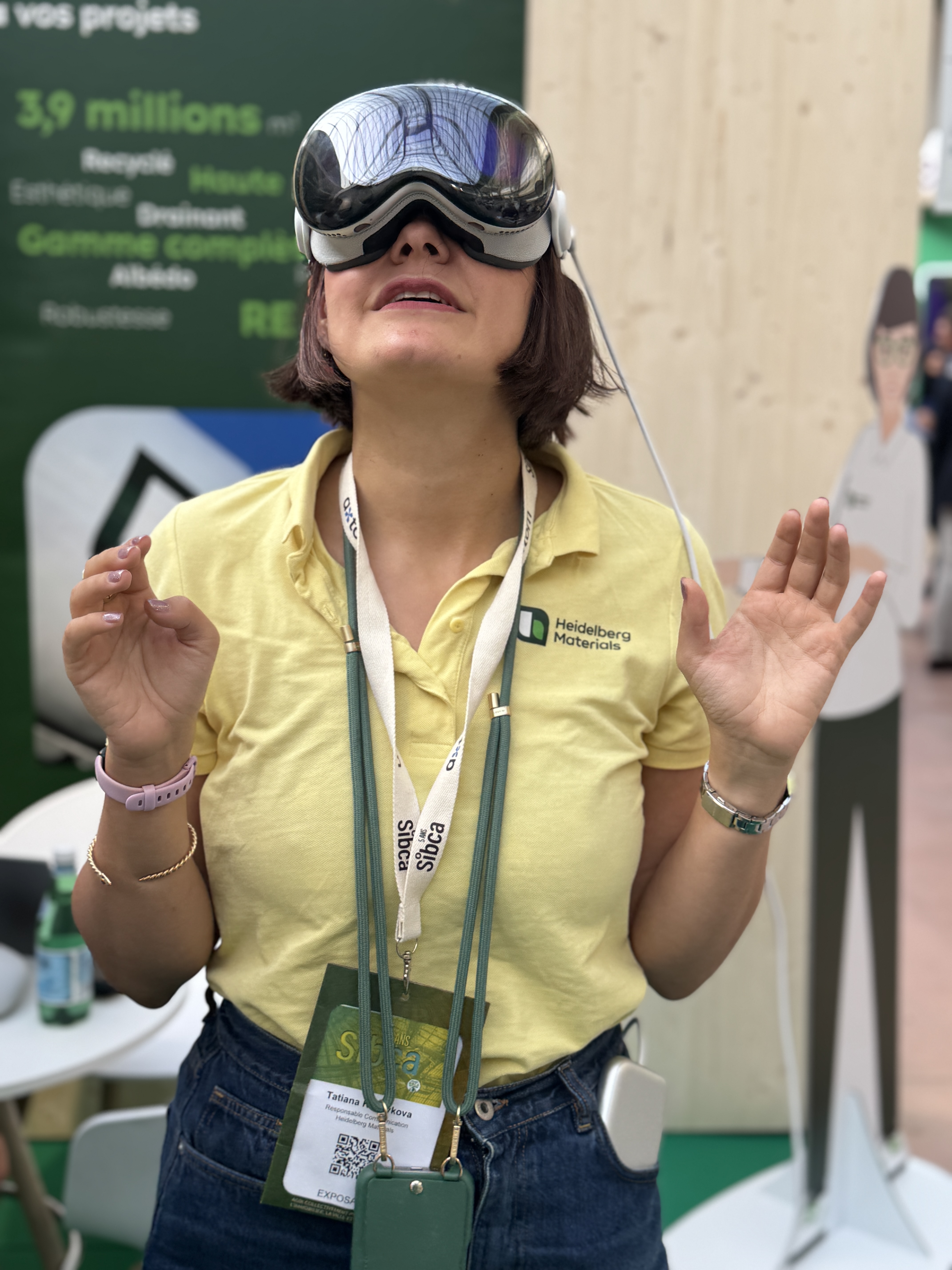Une femme porte un casque de réalité virtuelle lors d’un événement lié aux matériaux de construction.